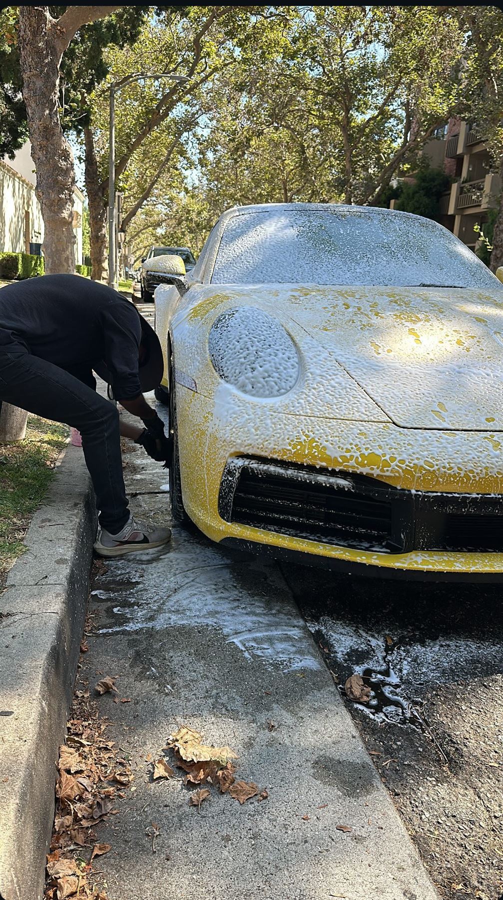 Porsche 911 covered in foam during a hand wash